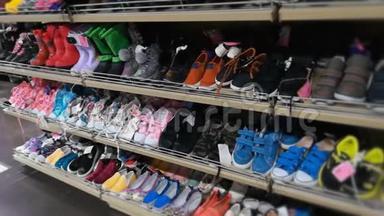 商店里有男孩、女孩和儿<strong>童鞋</strong>的架子。 儿<strong>童鞋</strong>、运动鞋和各种彩色靴子